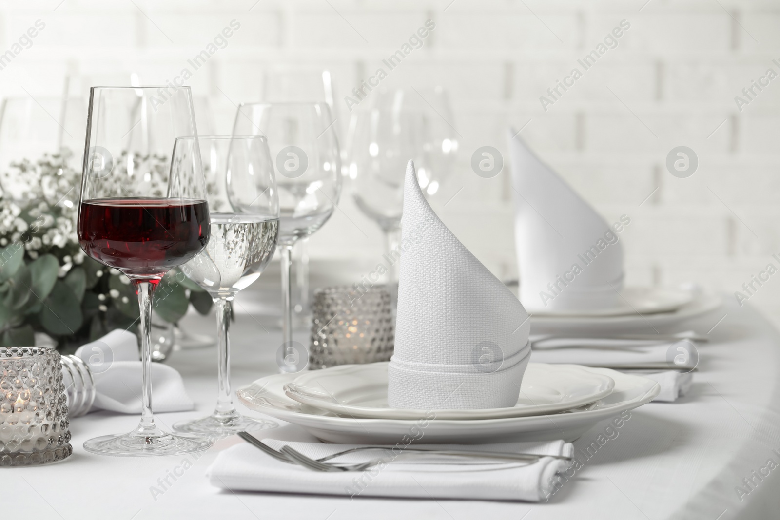 Photo of Glass of delicious wine and elegant table setting in restaurant