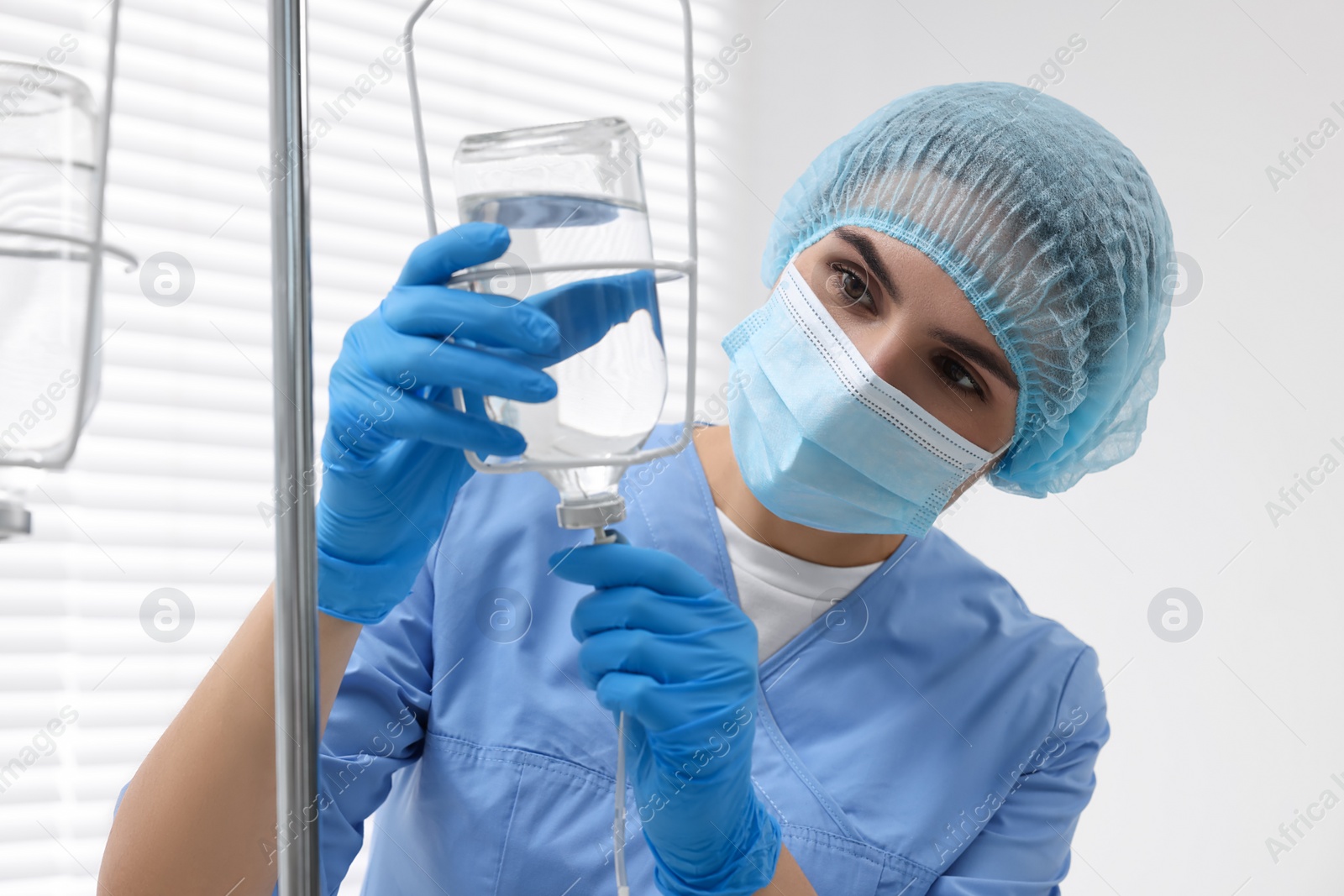 Photo of Nurse setting up IV drip in hospital