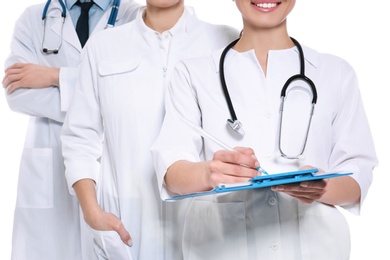 Doctor with clipboard and colleagues on white background, closeup. Unity concept