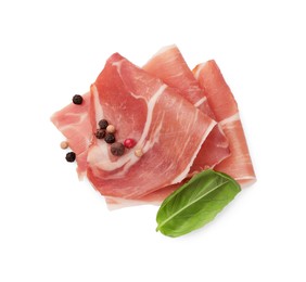 Photo of Slices of delicious jamon, spices and basil isolated on white, top view