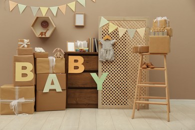 Photo of Gift boxes and toys in room decorated for baby shower party