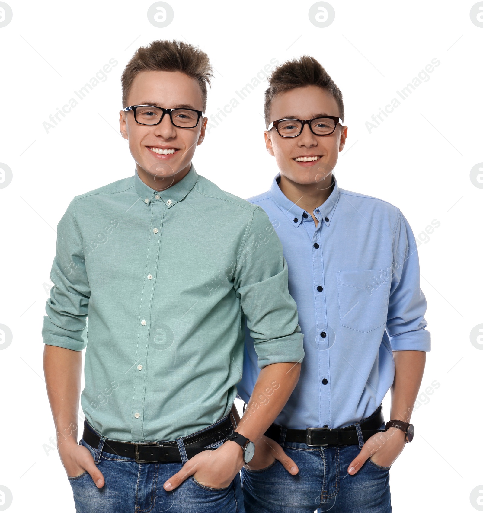 Photo of Teenage twin brothers with glasses on white background