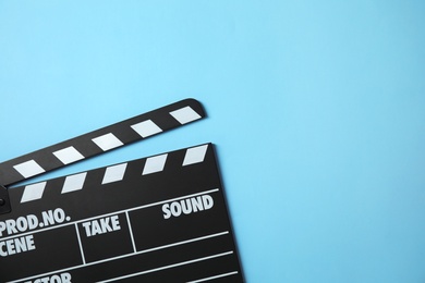 Photo of Clapperboard on color background, top view with space for text. Cinema production