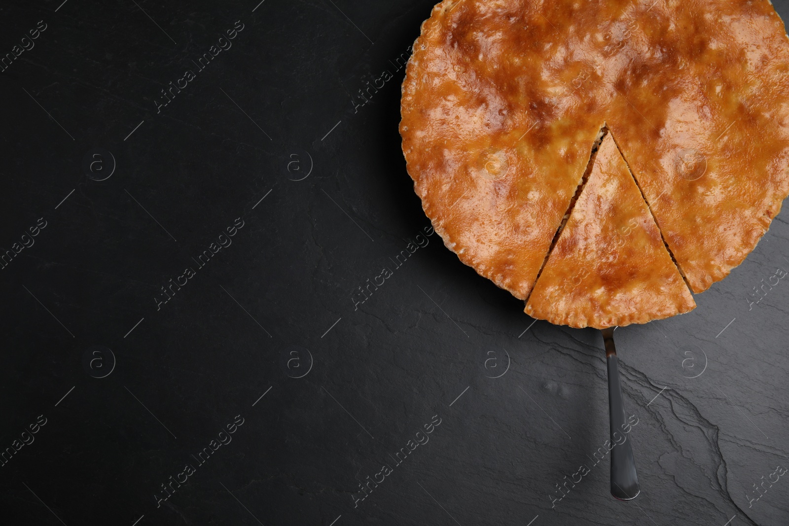 Photo of Delicious pie with meat on black table, top view. Space for text