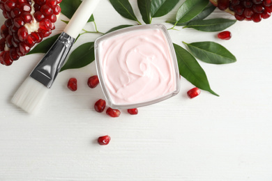 Flat lay composition with natural pomegranate facial mask on white wooden table