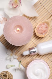 Beautiful spa composition with cosmetic products and flowers on white table, flat lay