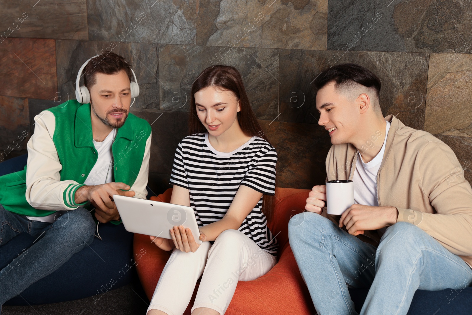 Photo of Office employees enjoying break together in recreation room at work