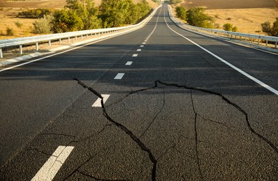 Large cracks on asphalt road after earthquake