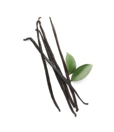 Photo of Aromatic vanilla pods and leaves isolated on white, top view