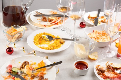 Food leftovers after party on table with cloth