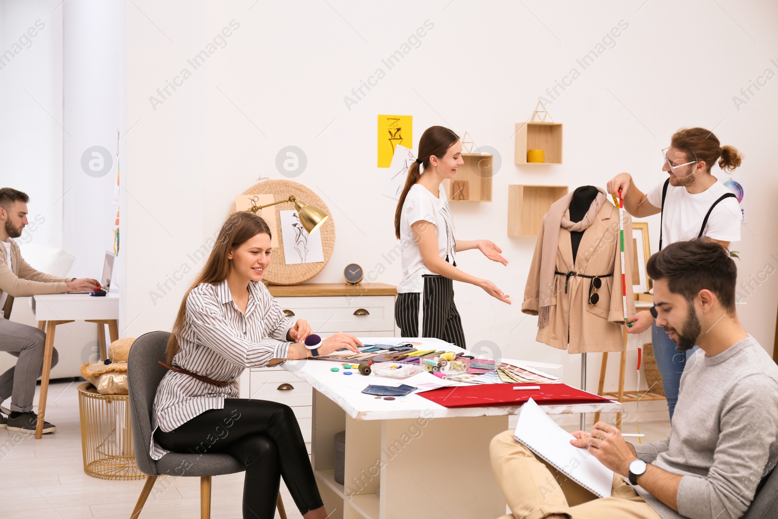 Photo of Fashion designers creating new clothes in studio