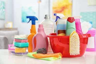 Photo of Set of cleaning supplies on table indoors