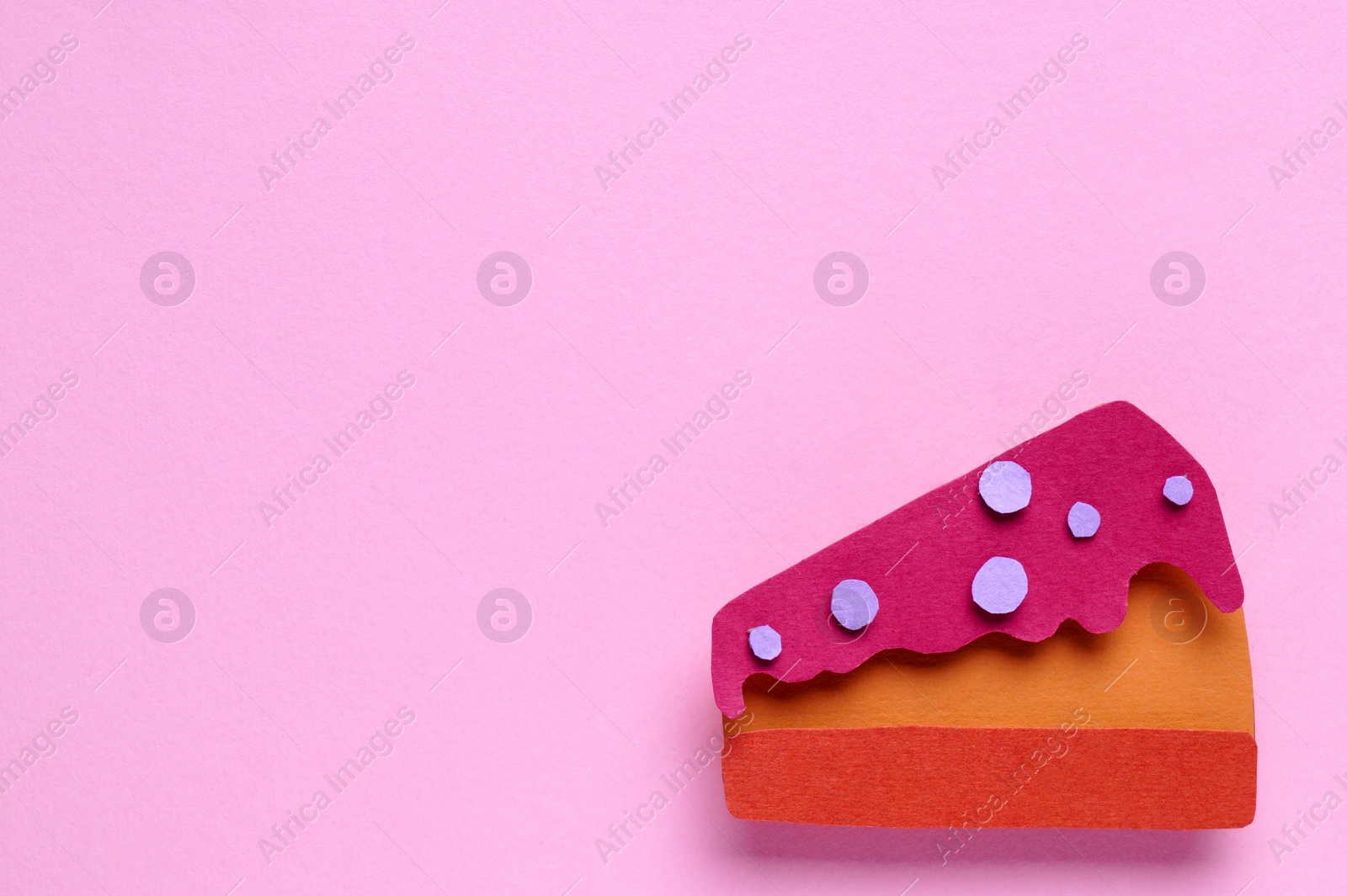 Photo of Birthday party. Piece of paper cake on pink background, top view. Space for text