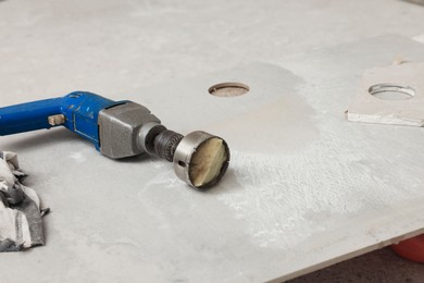 Buffing attachment drill on tile indoors, space for text