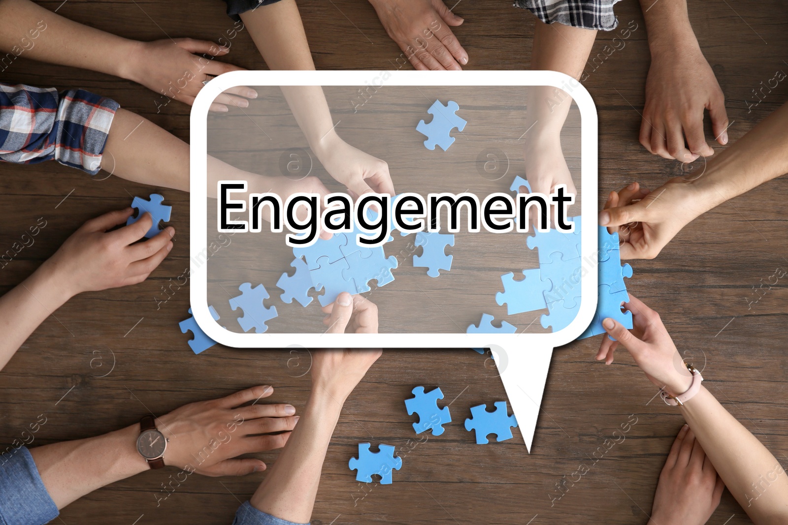 Image of Engagement concept. People with puzzle on table, top view