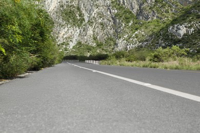 Photo of Picturesque view of big mountains and bushes near road