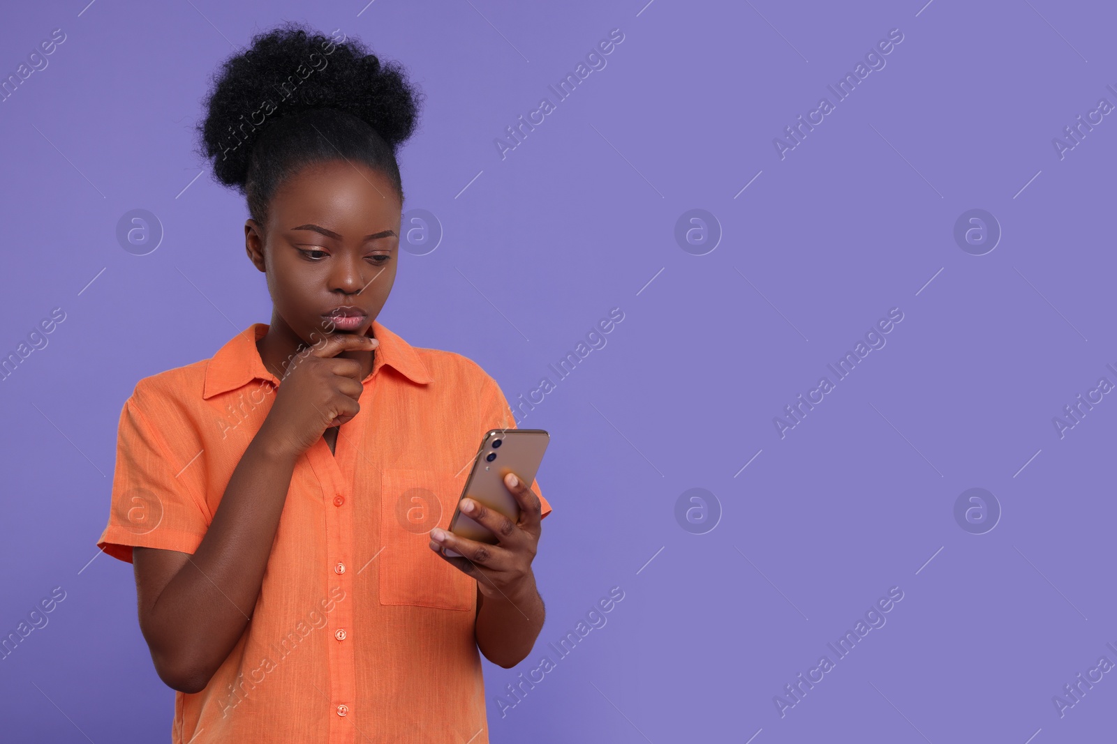 Photo of Beautiful young woman with smartphone on purple background. Space for text