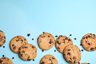 Delicious chocolate chip cookies on color background, flat lay. Space for text