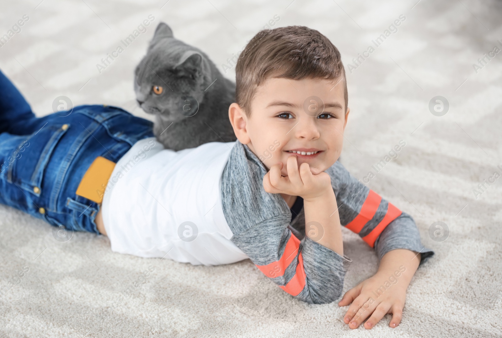 Photo of Cute little child with cat at home