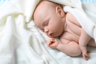 Cute newborn baby sleeping on white blanket