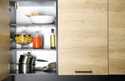 Products and kitchen utensils on modern shelving unit