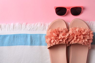 Photo of Flat lay composition with beach accessories on pink background