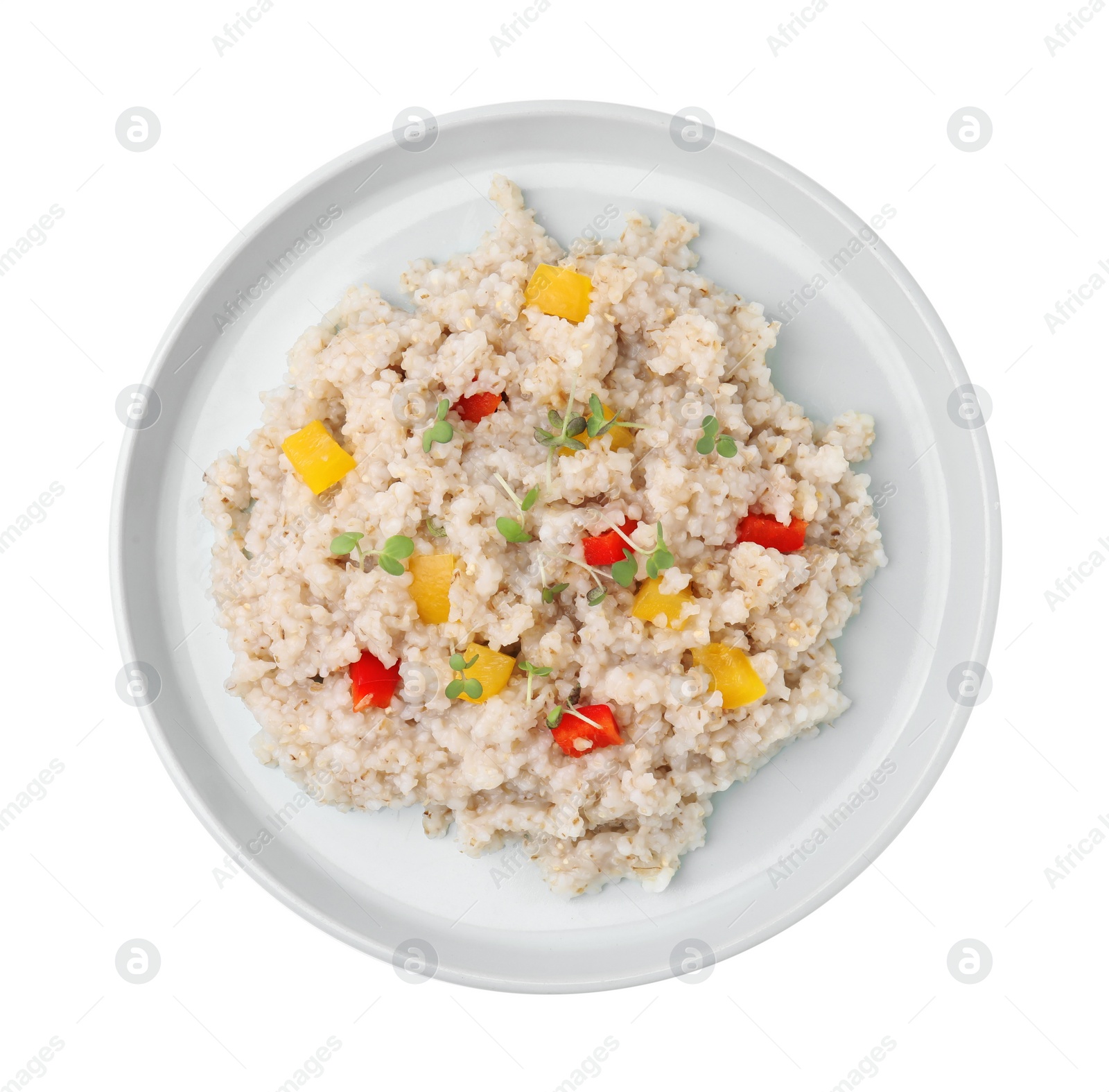 Photo of Delicious barley porridge with vegetables and microgreens isolated on white, top view
