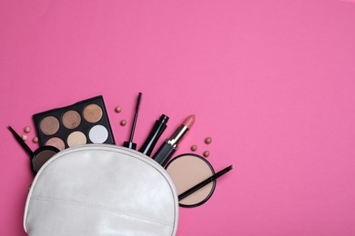 Cosmetic bag with makeup products and accessories on pink background, flat lay. Space for text