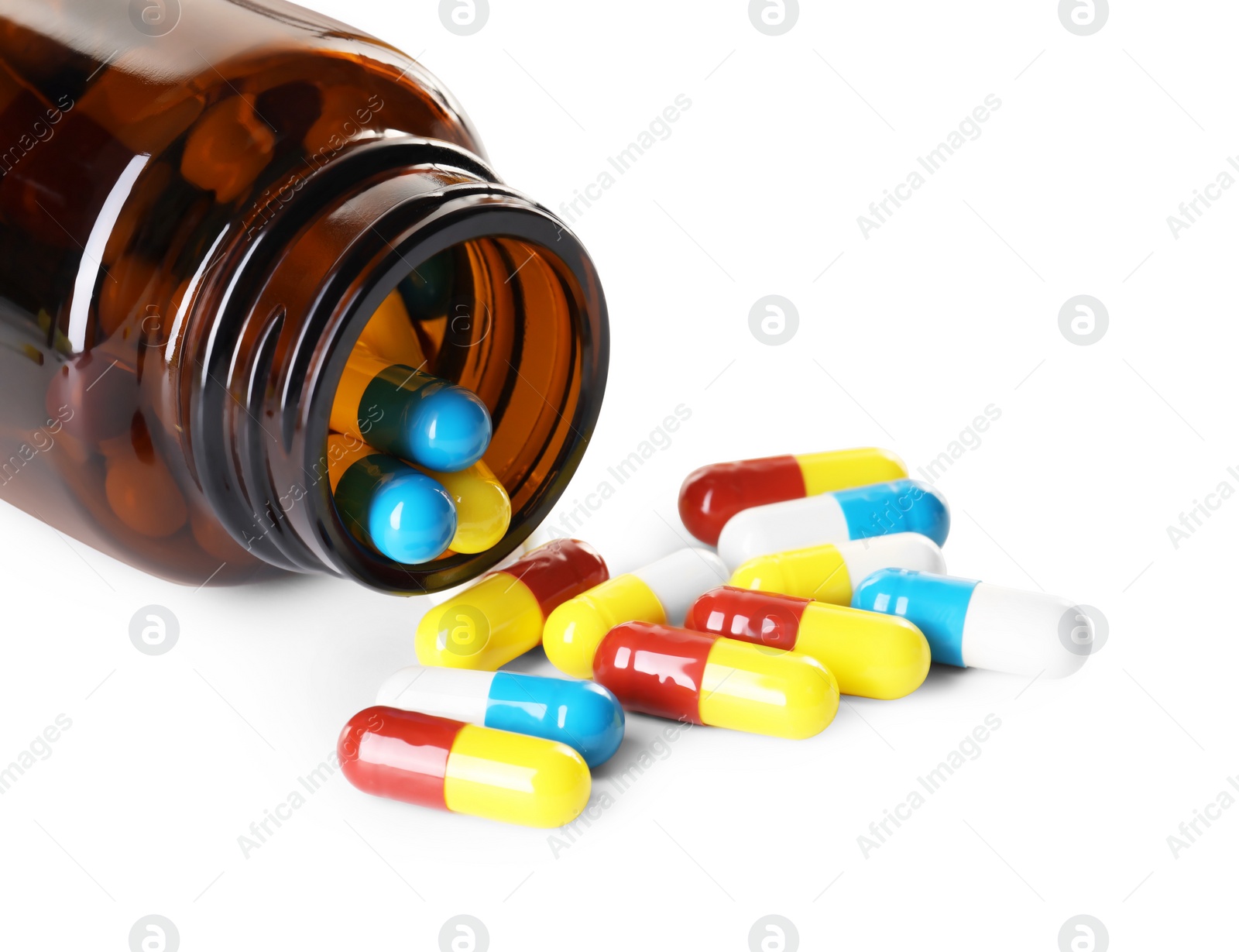 Photo of Scattered antibiotic pills and bottle isolated on white