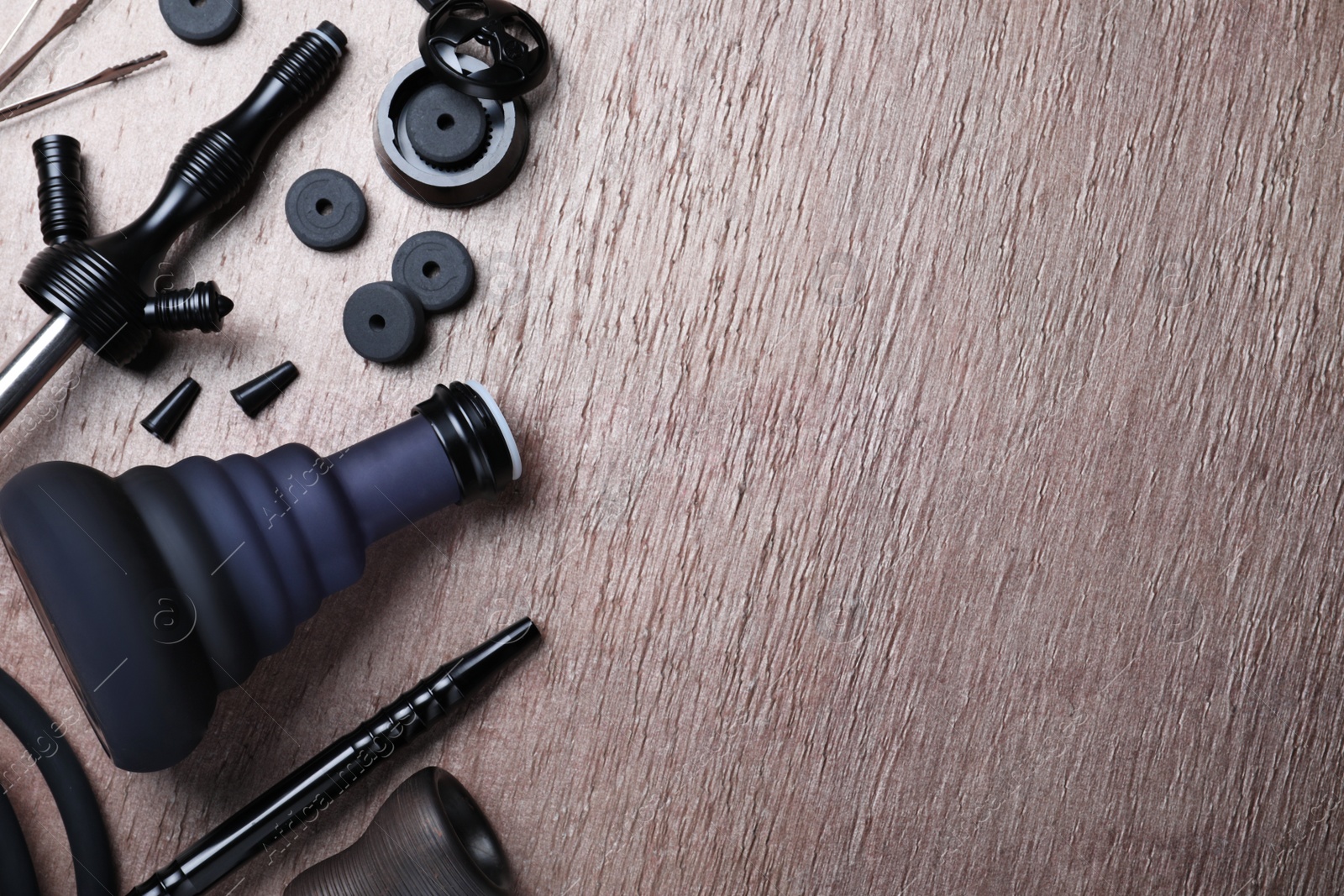 Photo of Flat lay composition with parts of hookah on wooden table, space for text