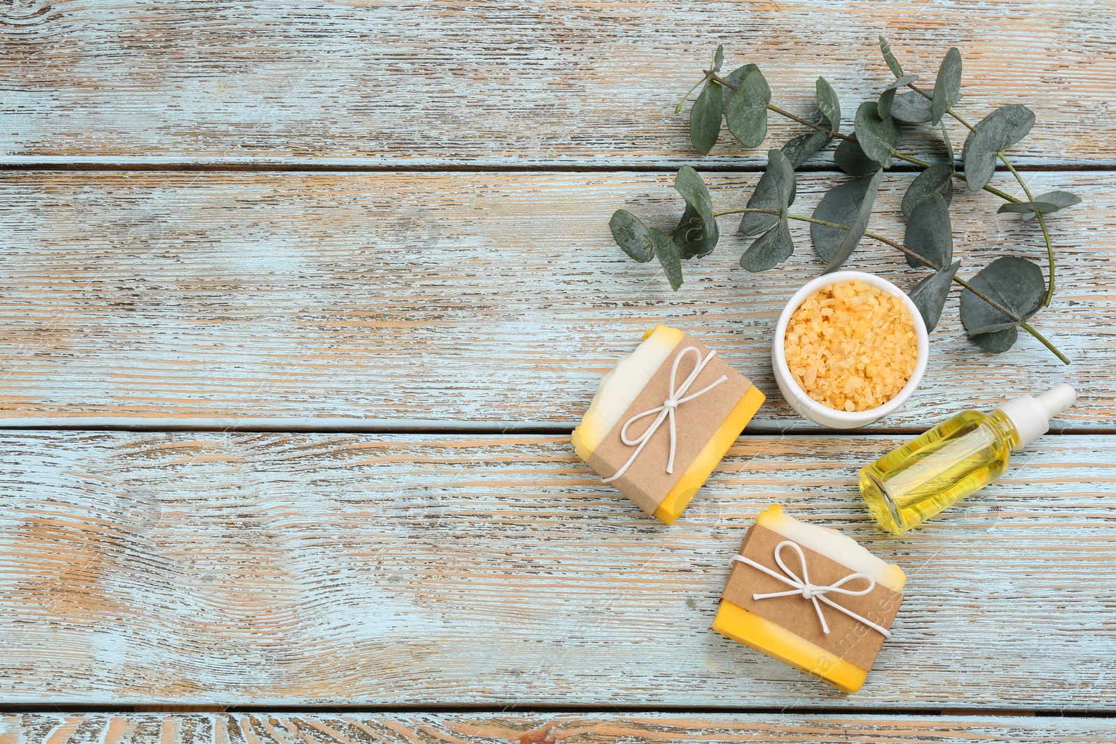 Photo of Flat lay composition with natural handmade soap on wooden background. Space for text