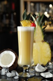 Photo of Tasty Pina Colada cocktail and ingredients on bar countertop