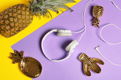 Photo of Flat lay composition with pineapple and headphones on color background