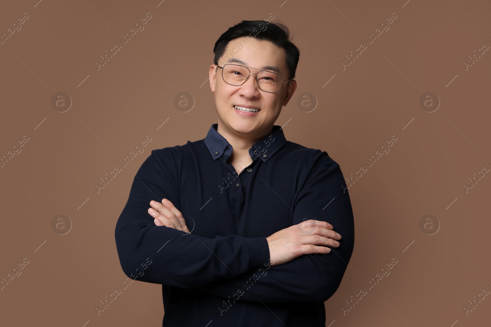 Photo of Portrait of happy man on brown background