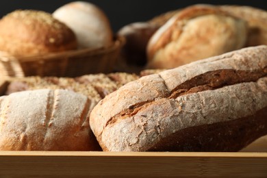 Baskets with different types of fresh bread on table, closeup