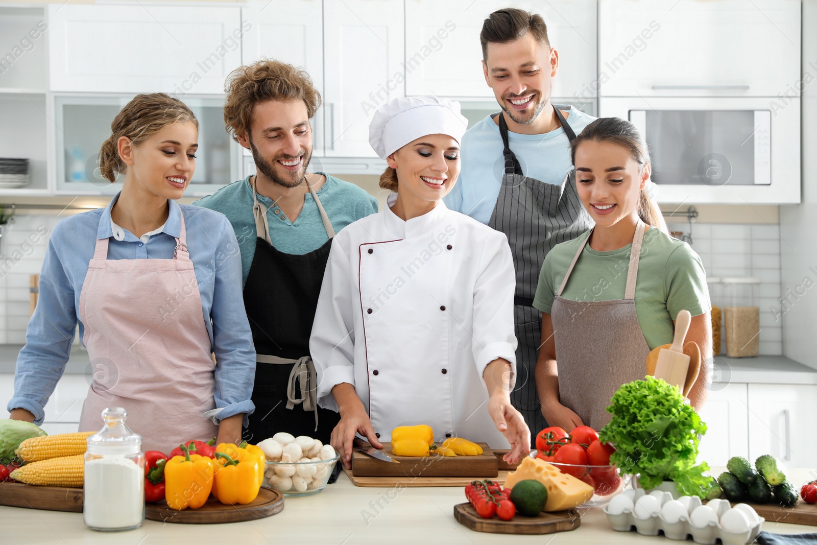 Photo of Group of people and female chef at cooking classes