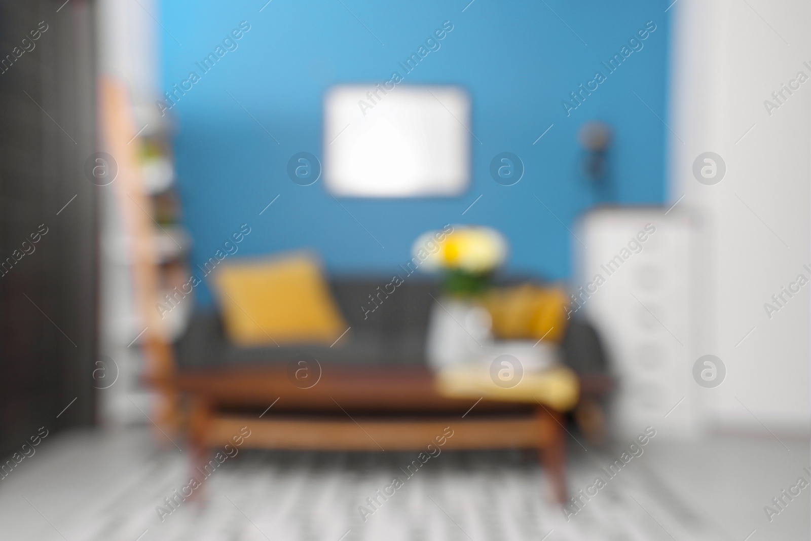 Photo of Blurred view of stylish living room interior with cozy sofa