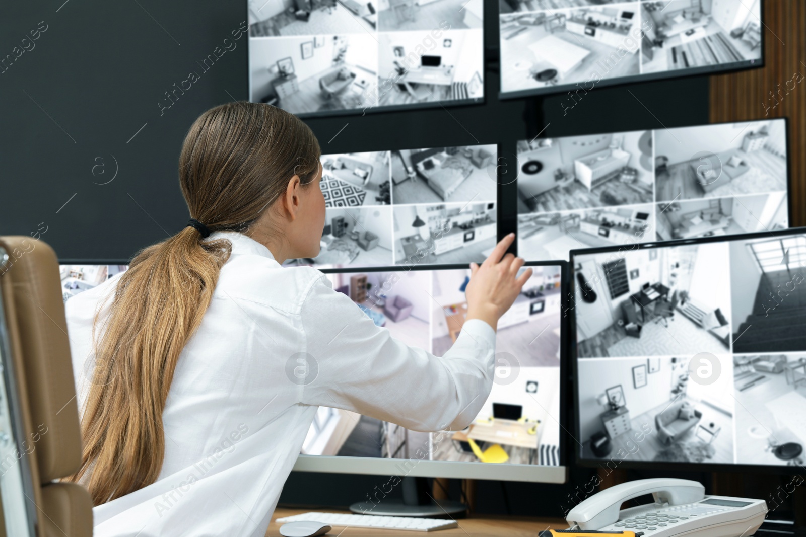 Photo of Security guard monitoring modern CCTV cameras indoors