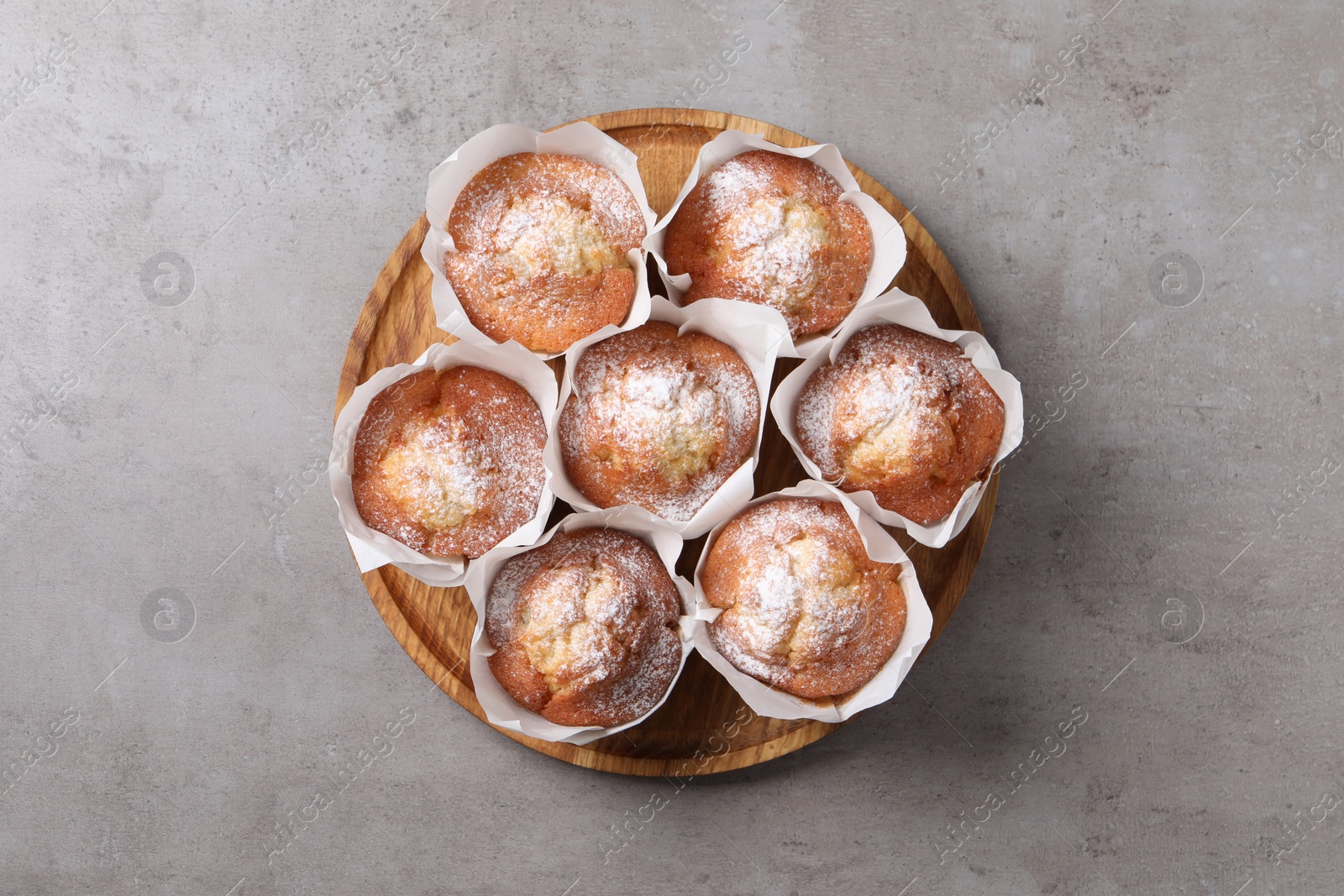 Photo of Delicious muffins on grey table, top view