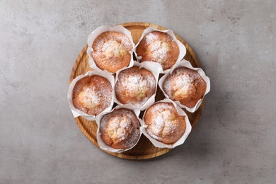 Delicious muffins on grey table, top view