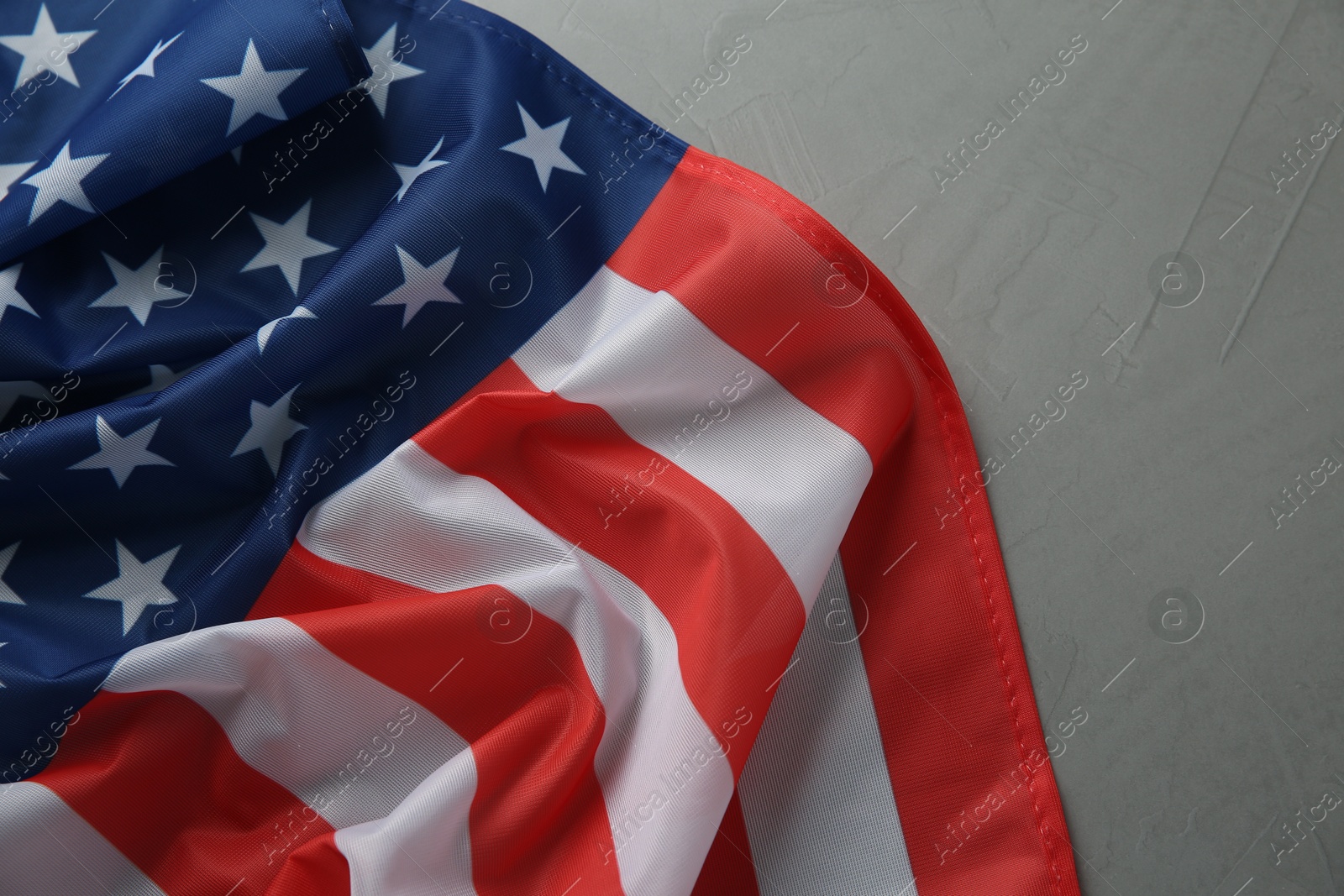 Photo of Flag of USA on light grey table, top view