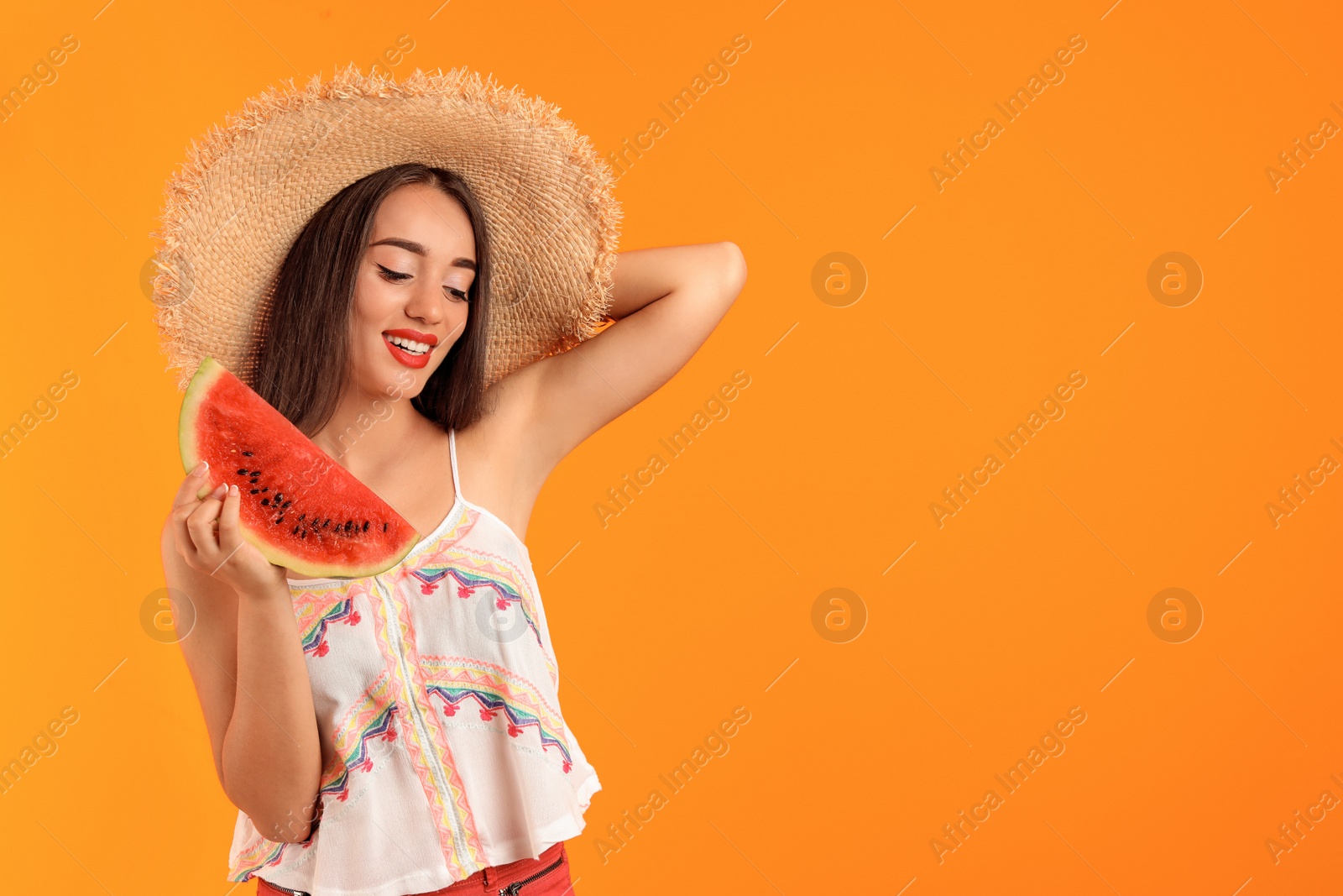 Photo of Beautiful young woman posing with watermelon on color background