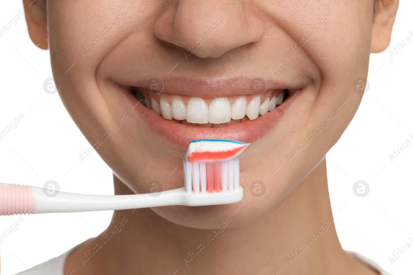 Photo of Woman brushing teeth with paste on white background, closeup. Dental care