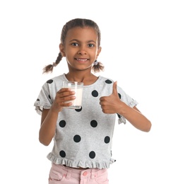 Adorable African-American girl with glass of milk on white background