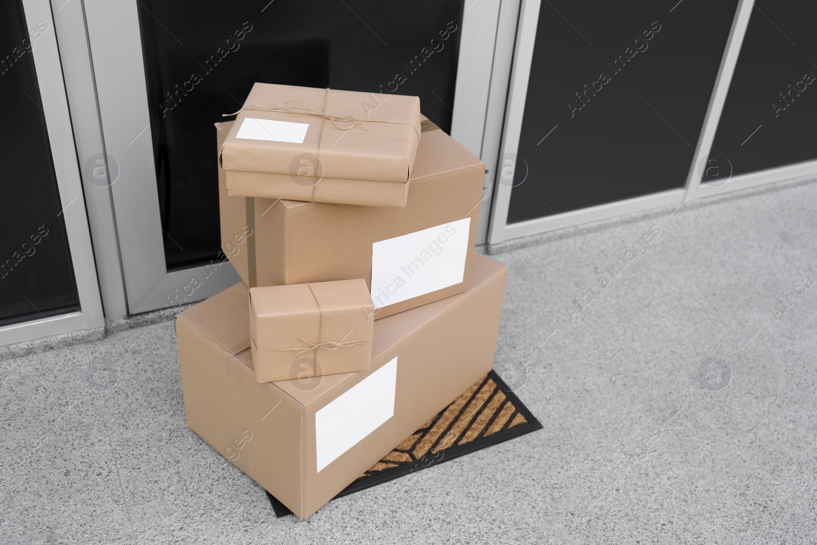 Photo of Delivered parcels on door mat near entrance