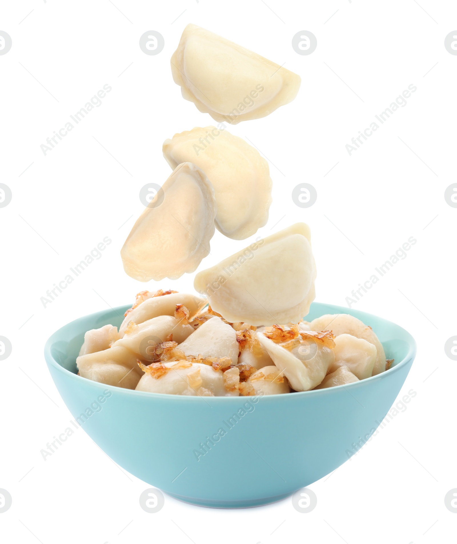 Image of Many tasty dumplings falling into bowl on white background