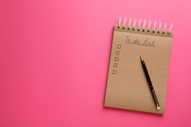 Photo of Notepad with unfilled To Do list and pen on pink background, top view. Space for text