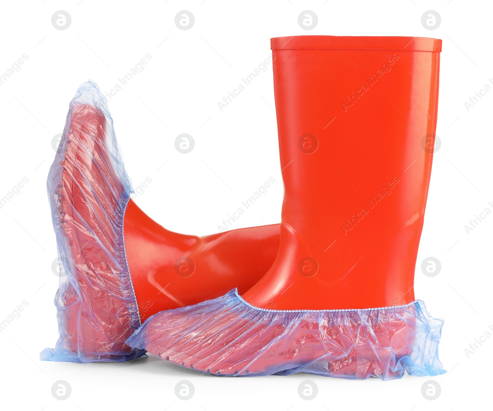 Photo of Rubber boots in blue shoe covers isolated on white