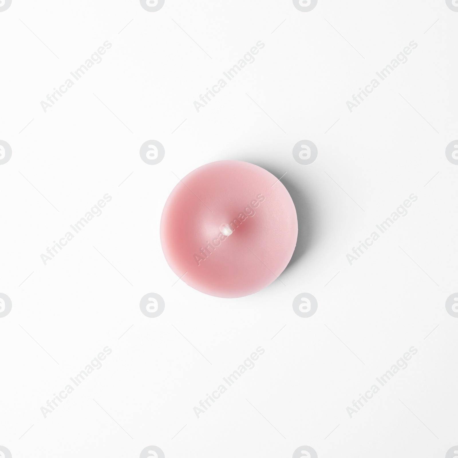 Photo of Pink wax decorative candle isolated on white, top view