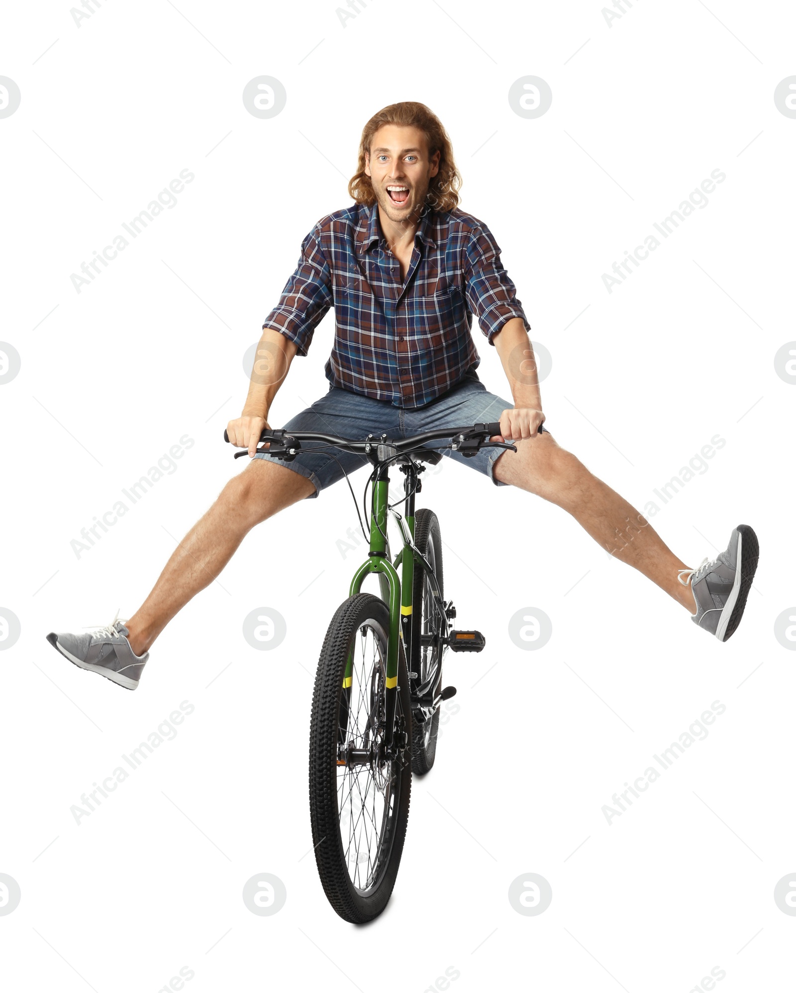 Photo of Happy young man riding bicycle on white background